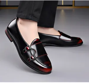 Detailed view of men's retro monk strap leather shoes with red patina finish.