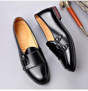 Close-up of black patent leather double monk strap men's shoes with vintage buckle detail