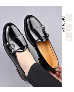 Detail view of men's black monk strap leather shoes with glossy finish