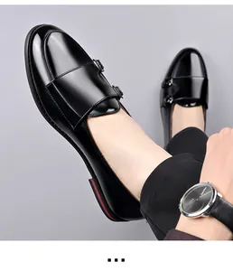 Detail view of stylish black glossy leather monk strap shoes for men with buckles