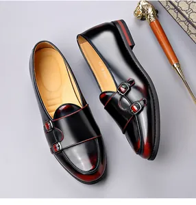 Detailed view of black and red gradient leather monk strap shoes with double buckles.