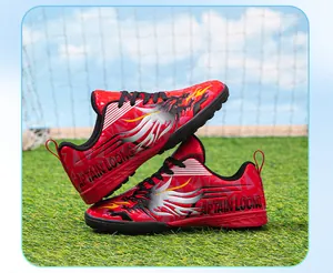 Detailed side view of red children's TF soccer shoes with cool dragon patterns and text