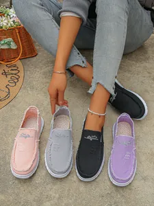 Fashionable colorful women's canvas slip-on loafers with distressed frayed edge detail