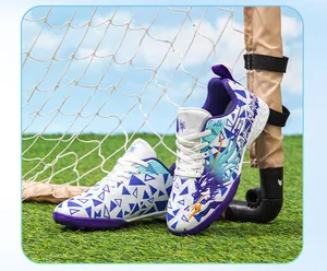 Close-up detail of children's soccer shoes with blue geometric prints and durable TF soles