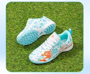 Side view and textured TF turf sole of kids' white and blue soccer shoes