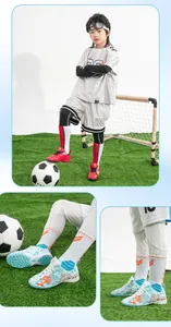 Detail view of professional children's TF soccer shoes with anti-slip patterns for turf