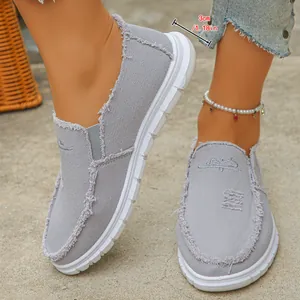 Detail view of grey canvas slip-on shoes showing the 3cm heel height