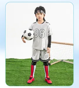 Professional red kids soccer shoes featuring turf studs and secure velcro for training.