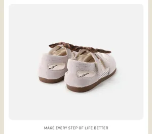 Detailed rear view of toddler girl's soft sole shoes featuring mesh and plaid bow