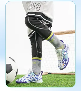 Professional kids turf soccer shoes with non-slip studs on artificial grass soccer field
