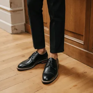 Detail of classic black leather Oxford shoes for men in a professional setting.