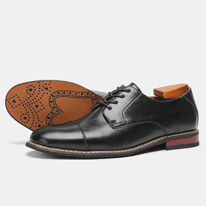 Close-up of classic black men's leather business dress shoes with decorative sole