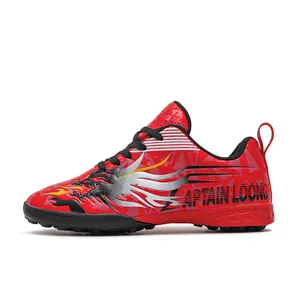 Red children's turf soccer shoes with dragon graphics and Captain Loong logo