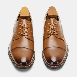 Top-down view of classic brown leather dress shoes for men with wooden shoe trees