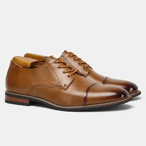 Close-up view of classic brown leather dress shoes with a stylish gradient cap toe detail