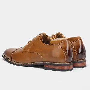 Rear-side view of classic brown leather dress shoes showing texture and heel detail