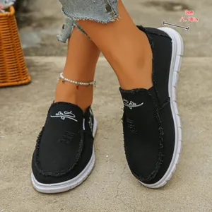 Close-up detail showing 3cm (1.18in) thick white sole of black slip-on canvas shoes