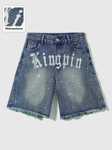 Detail view of men's blue denim shorts with Kingpin lettering and rhinestone accents.