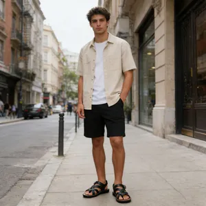 Detailed view of men's black Roman sandals with toe-loop design on a city street