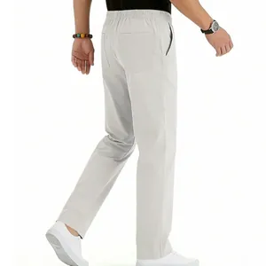 Detail view of men's minimalist light gray straight leg trousers for summer wear
