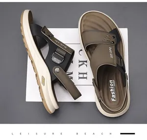 Overhead view of men's brown and black breathable beach sandals on a minimalist background