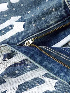 Macro view showing the metallic zipper and rhinestone detail on men's blue denim shorts
