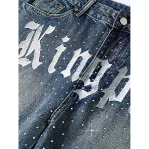 Men's blue washed denim shorts with white gothic print and scattered rhinestone studs