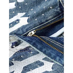 Men's distressed blue denim shorts with rhinestone studs and white gothic print detail