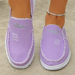 Fashionable purple canvas slip-on loafers for women featuring trendy frayed edge details