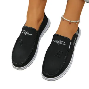 Fashionable black women's canvas slip-on loafers with distressed daisy floral detail