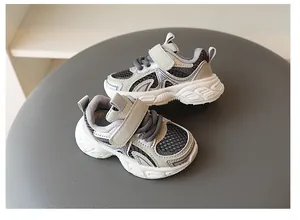 Close-up of breathable mesh boys' sports shoes with velcro strap in grey