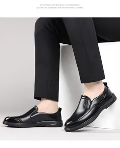 Side view detail of men's black leather slip-on business loafers worn by a model