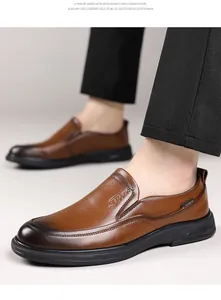 Close-up of brown leather slip-on loafers worn by a male model for business casual style