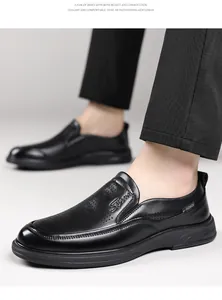 Detailed macro view of stylish black perforated leather slip-on loafers for men
