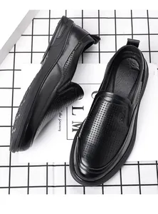 Detailed view of black perforated leather loafers for men with a breathable design.