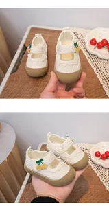 Close-up of breathable mesh princess shoes for baby girls with cute cherry details