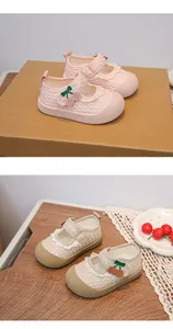 Detailed macro view showing the lace trim and cherry design on baby girl mesh shoes