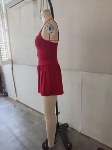 Side view of a burgundy sleeveless romper jumpsuit on a mannequin