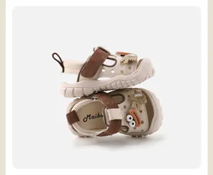 Gros plan de mignonnes sandales de marche pour bébé avec motifs de dessins animés