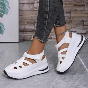 Detailed side view of white platform Roman sandals featuring hook-and-loop straps