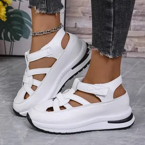 Close-up view of stylish white platform Roman sandals featuring adjustable velcro straps