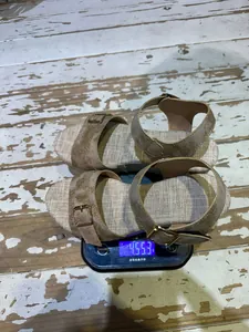 Detailed weight demonstration of women's linen texture wedge sandals on a scale.