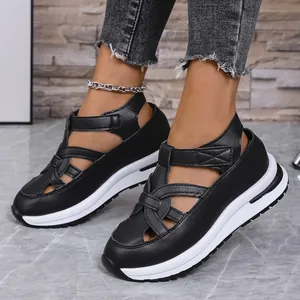 Side view close-up of black platform sandals featuring Roman straps and velcro closure