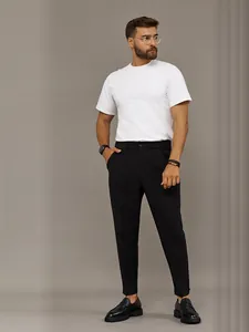 Model wearing black slim-fit business trousers paired with a white t-shirt and loafers.