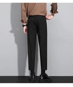 Back view of professional men's slim fit black business trousers in nine-point length