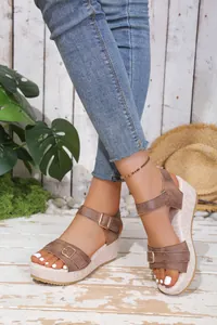 Detailed view of stylish brown peep-toe wedge sandals with buckles and platform