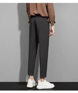 Rear view of men's slim-fit business trousers with ankle-length cut and elastic waistband