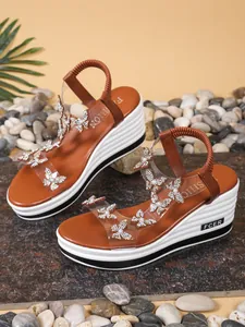 Brown wedge sandals with rhinestone butterfly decor and transparent PVC straps