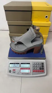 Grey platform high heel sandals weighing 352.9g on a digital scale for detail reference.