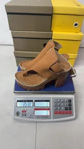 Weight measurement of brown chunky platform sandals showing 353 grams on a digital scale